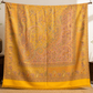Mustard pashmina wool shawl folded, showing the woven paisley detail
