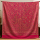 Pink pashmina wool shawl folded, showing the woven paisley detail