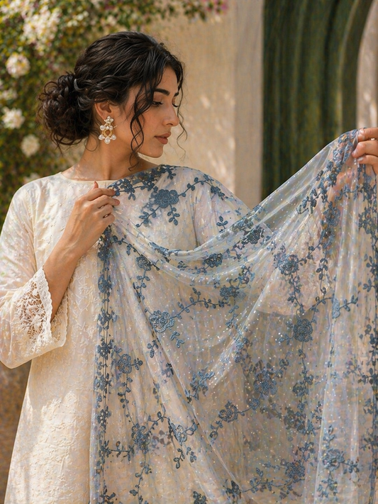 Woman holding a floral embroidered fabric in an outdoor setting