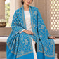 Ferozi blue patterned shawl in an elegant seated wrap on a female model in an Indian heritage haveli