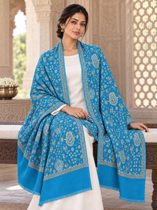 Ferozi blue patterned shawl in an elegant seated wrap on a female model in an Indian heritage haveli
