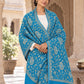 Ferozi blue patterned shawl in an elegant front crossed wrap on a female model in an Indian heritage haveli