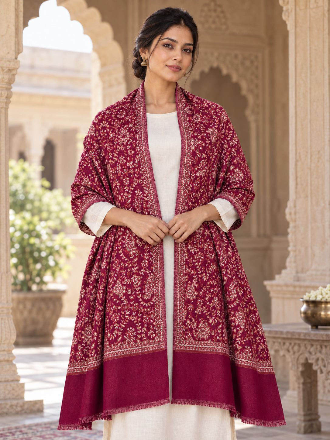 MAROON patterned shawl in an elegant open shoulder drape on a female model in an Indian heritage haveli