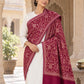 MAROON patterned shawl in an elegant one-shoulder drape on a female model in an Indian heritage haveli