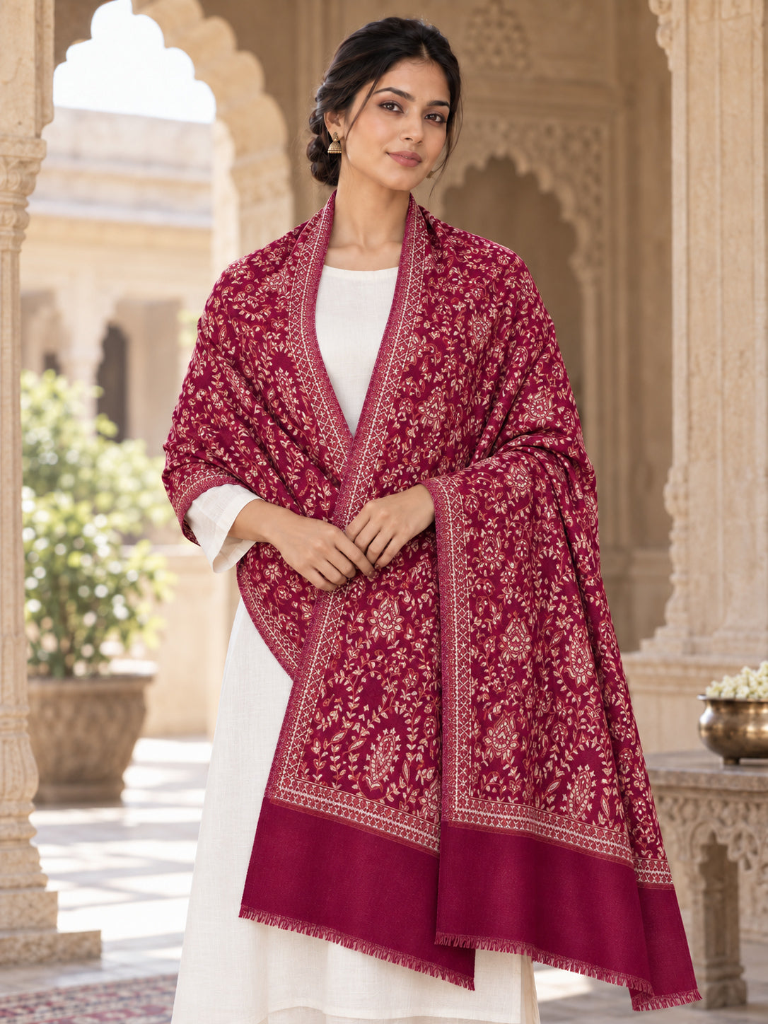 MAROON patterned shawl in an elegant front crossed wrap on a female model in an Indian heritage haveli