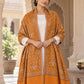 Mustard patterned shawl in an elegant open shoulder drape on a female model in a heritage haveli