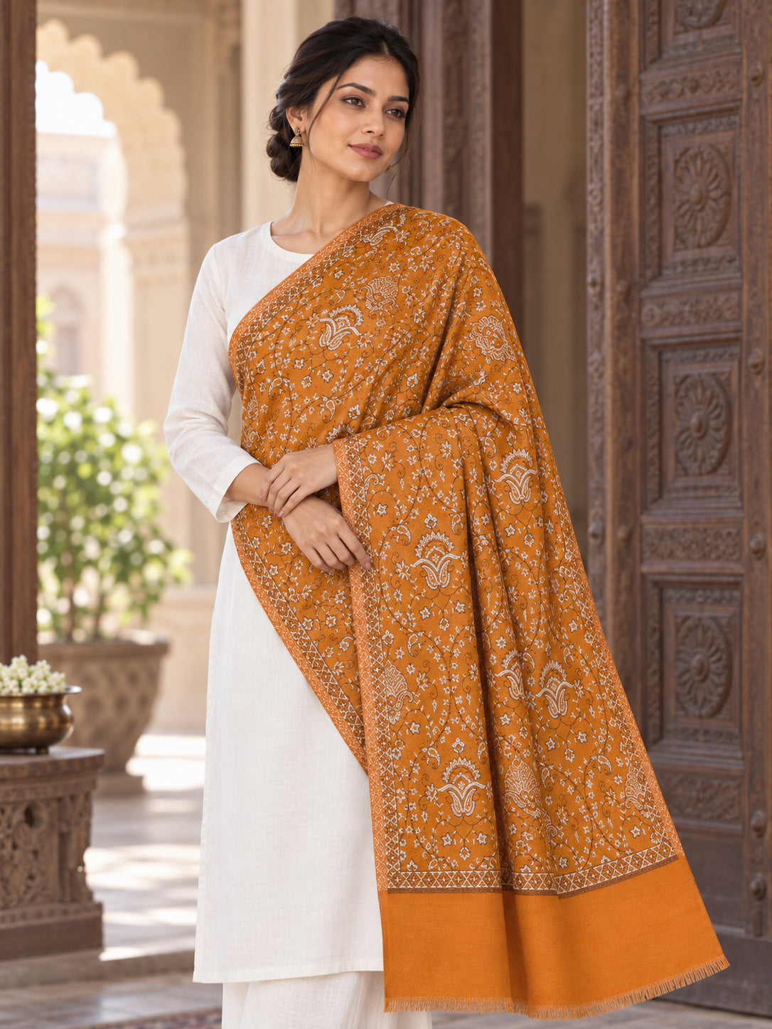 Mustard patterned shawl in an elegant one-shoulder drape with a carved haveli doorway