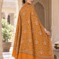 Rear view of the mustard shawl showing its ivory motifs and broad plain end border