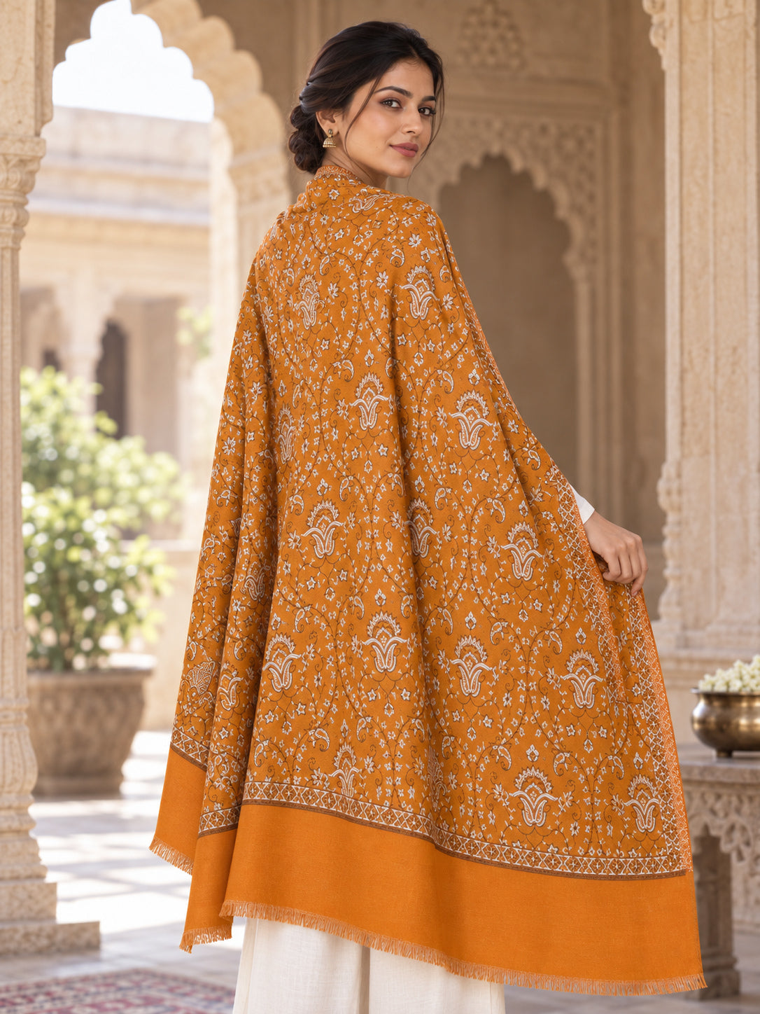 Rear view of the mustard shawl showing its ivory motifs and broad plain end border