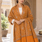 Mustard patterned shawl in an elegant front wrap on a female model in a heritage haveli