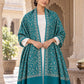Green patterned shawl in an elegant open shoulder drape on a female model in an Indian heritage haveli