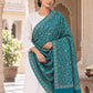 Green patterned shawl in an elegant one-shoulder drape on a female model in an Indian heritage haveli