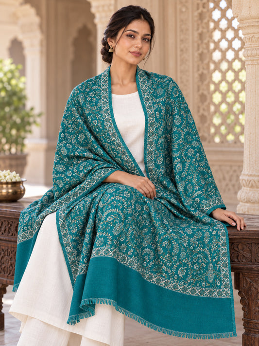 Green patterned shawl in an elegant seated wrap on a female model in an Indian heritage haveli