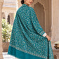 Green patterned shawl in an elegant rear drape on a female model in an Indian heritage haveli