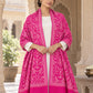 Rani pink patterned shawl in an elegant open shoulder drape on a female model in an Indian heritage haveli