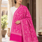 Rani pink patterned shawl in an elegant one-shoulder drape on a female model in an Indian heritage haveli