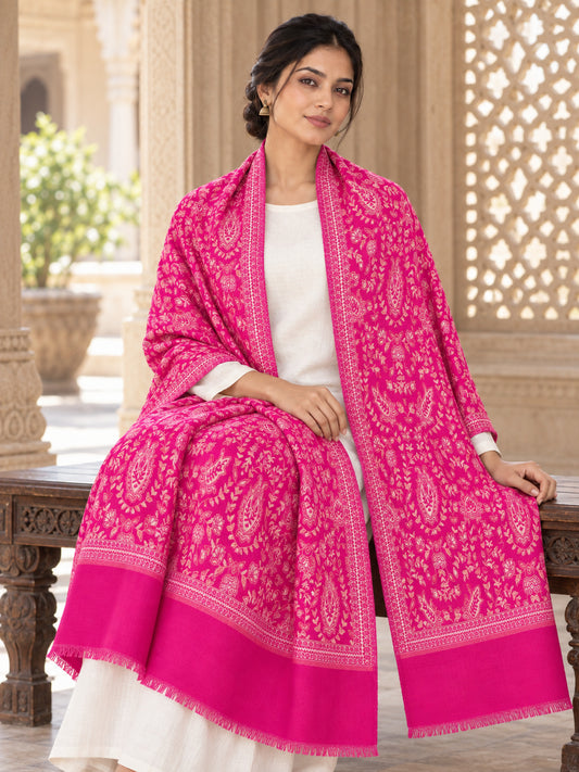 Rani pink patterned shawl in an elegant seated wrap on a female model in an Indian heritage haveli