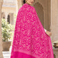 Rani pink patterned shawl in an elegant rear drape on a female model in an Indian heritage haveli
