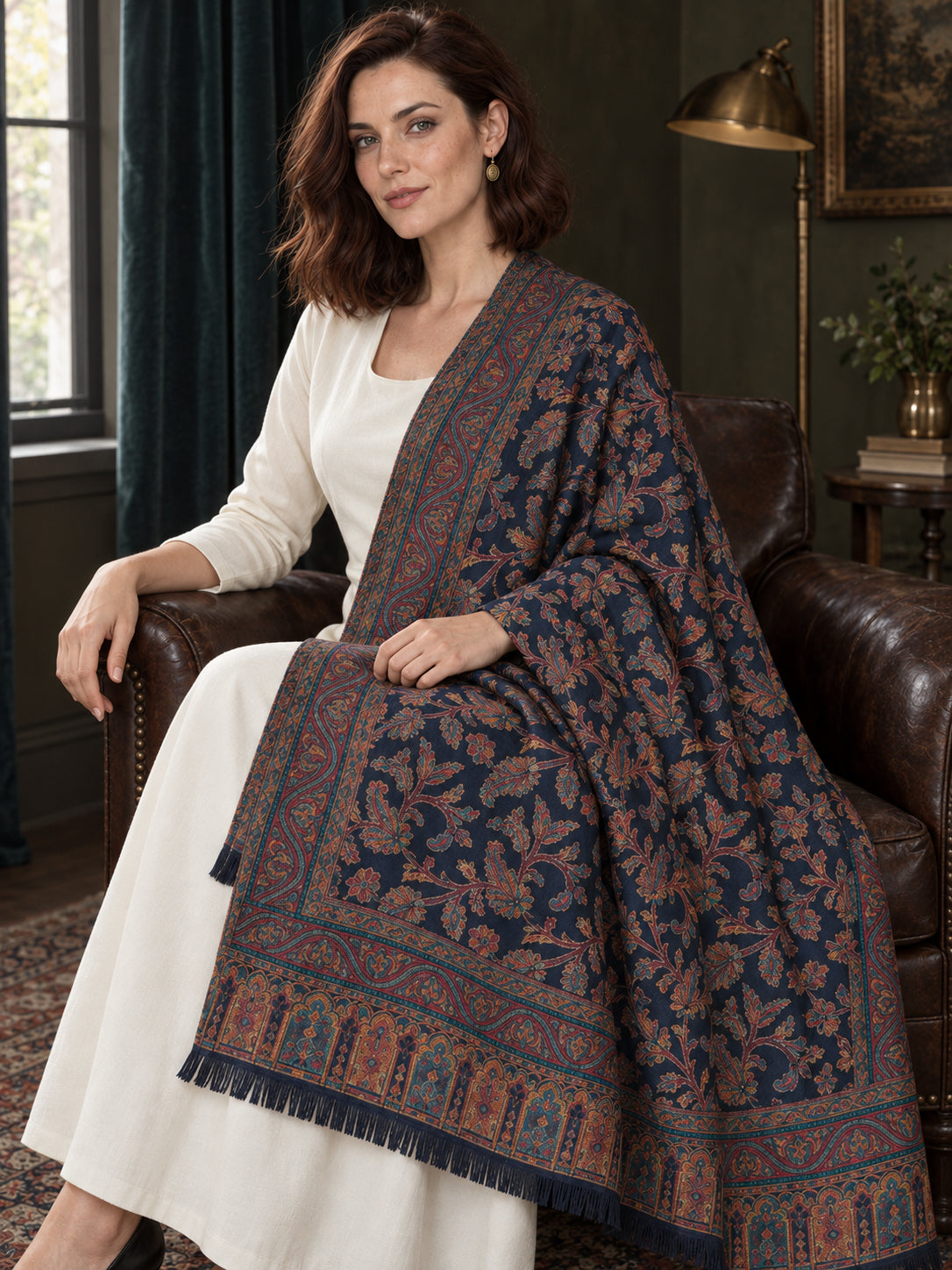 Navy Blue Kani shawl — seated wrap in a dark olive sitting room | WV-401-NAVYBLUE-4