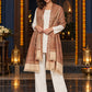 Beige paisley woven shawl styled on a model in a luxurious festive palace setting — long stole
