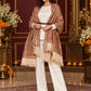 Beige paisley woven shawl styled on a model in a luxurious festive palace setting — belted wrap