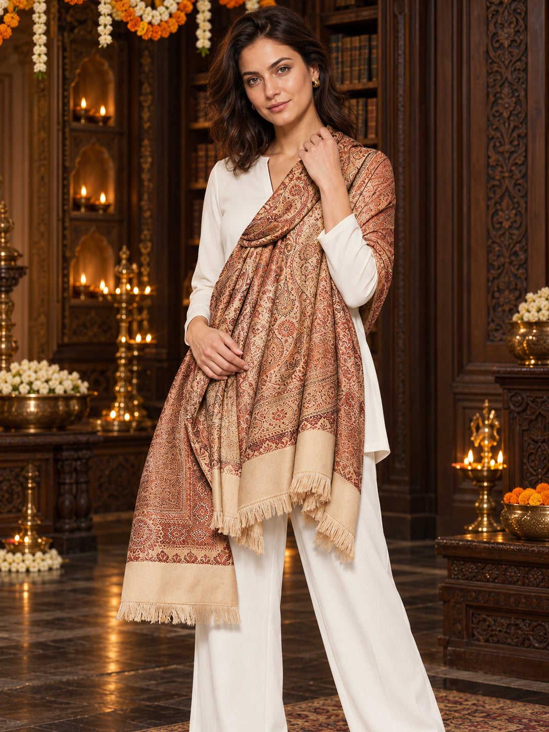 Beige paisley woven shawl styled on a model in a luxurious festive palace setting — single-shoulder styling