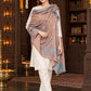 Grey paisley woven shawl styled on a model in a luxurious festive palace setting — single-shoulder styling