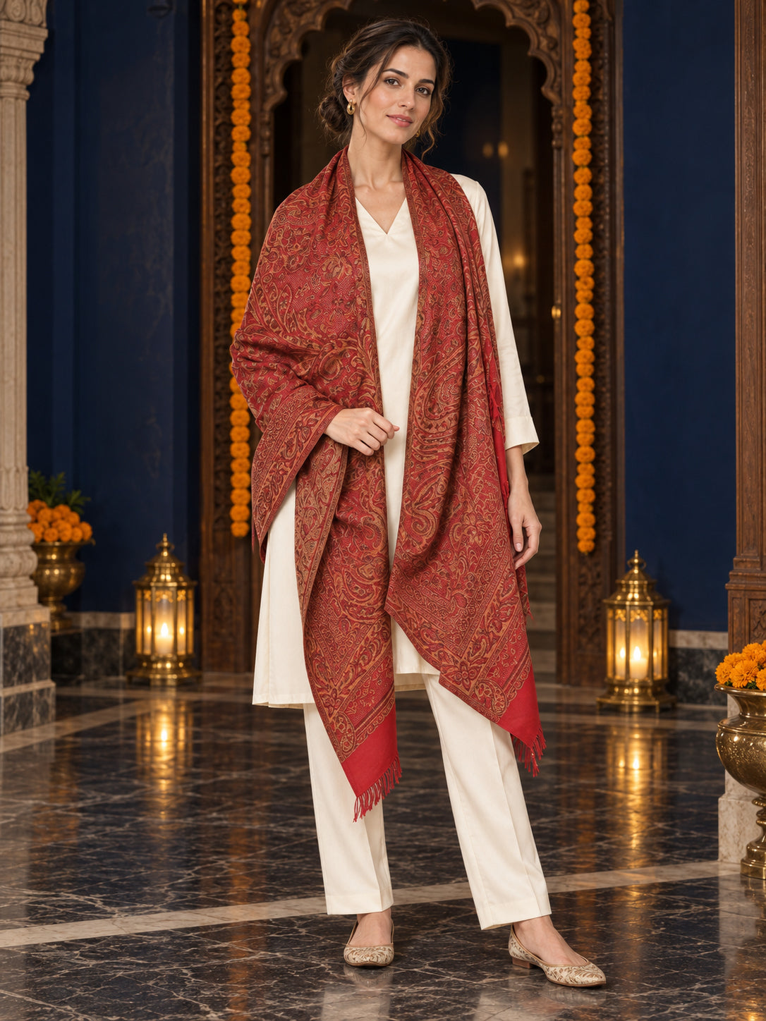 Maroon paisley woven shawl styled on a model in a luxurious festive palace setting — long stole