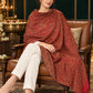 Maroon paisley woven shawl styled on a model in a luxurious festive palace setting — seated salon