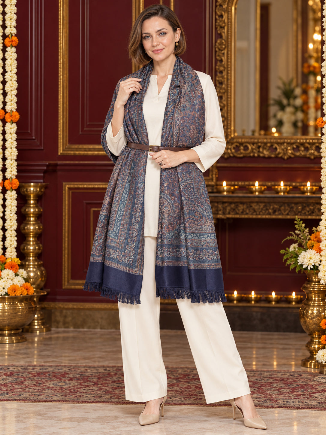 Navy Blue paisley woven shawl styled on a model in a luxurious festive palace setting — belted wrap