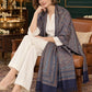 Navy Blue paisley woven shawl styled on a model in a luxurious festive palace setting — seated salon