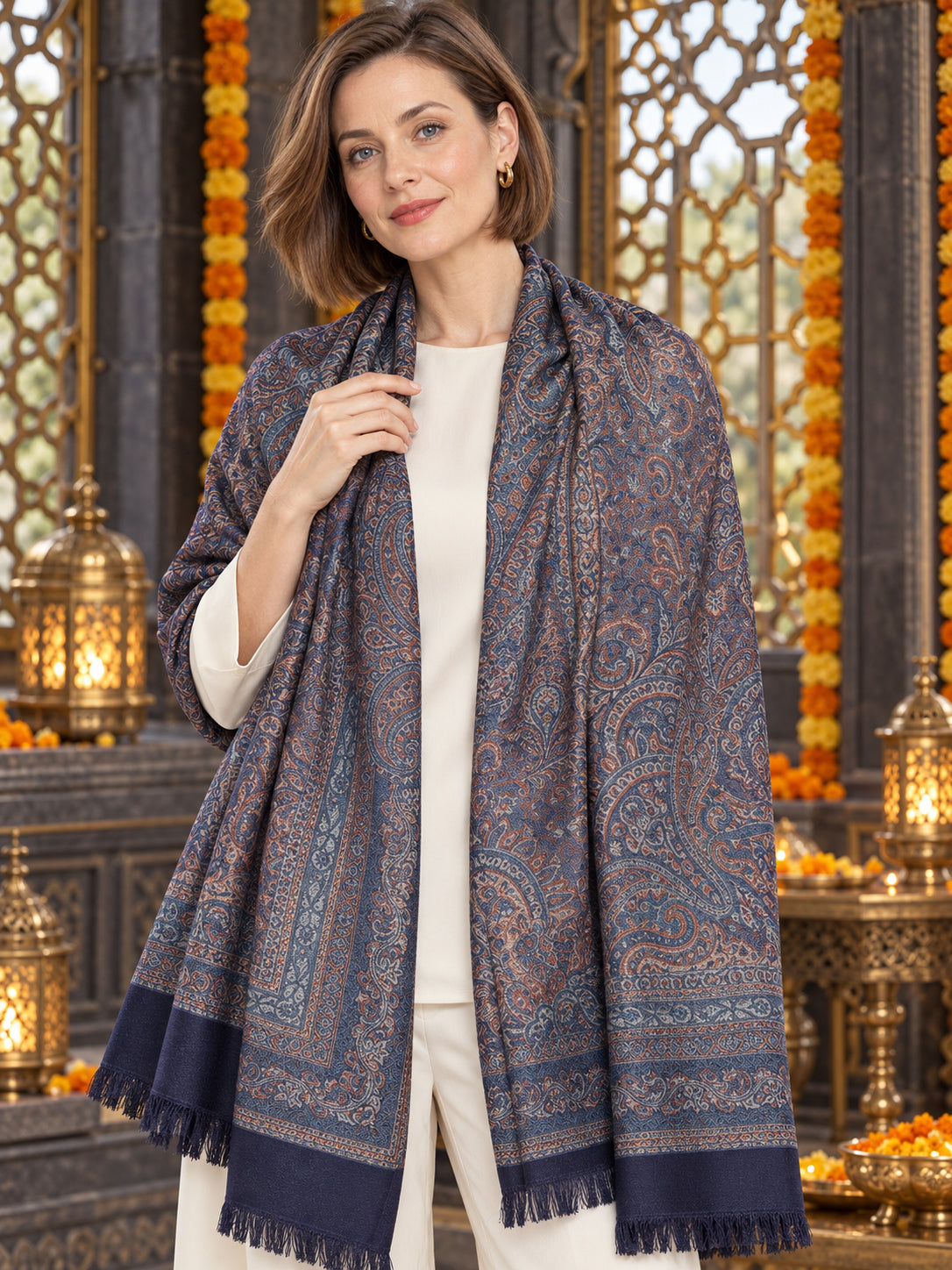 Navy Blue paisley woven shawl styled on a model in a luxurious festive palace setting — detailed shoulder wrap