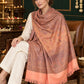 Peach paisley woven shawl styled on a model in a luxurious festive palace setting — seated salon