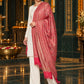 Pink paisley woven shawl styled on a model in a luxurious festive palace setting — standing showcase