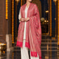 Pink paisley woven shawl styled on a model in a luxurious festive palace setting — long stole