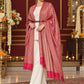 Pink paisley woven shawl styled on a model in a luxurious festive palace setting — belted wrap