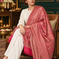 Pink paisley woven shawl styled on a model in a luxurious festive palace setting — seated salon
