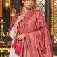 Pink paisley woven shawl styled on a model in a luxurious festive palace setting — detailed shoulder wrap