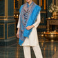 Sky Blue paisley woven shawl styled on a model in a luxurious festive palace setting — standing showcase