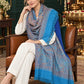 Sky Blue paisley woven shawl styled on a model in a luxurious festive palace setting — seated salon