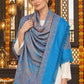Sky Blue paisley woven shawl styled on a model in a luxurious festive palace setting — detailed shoulder wrap