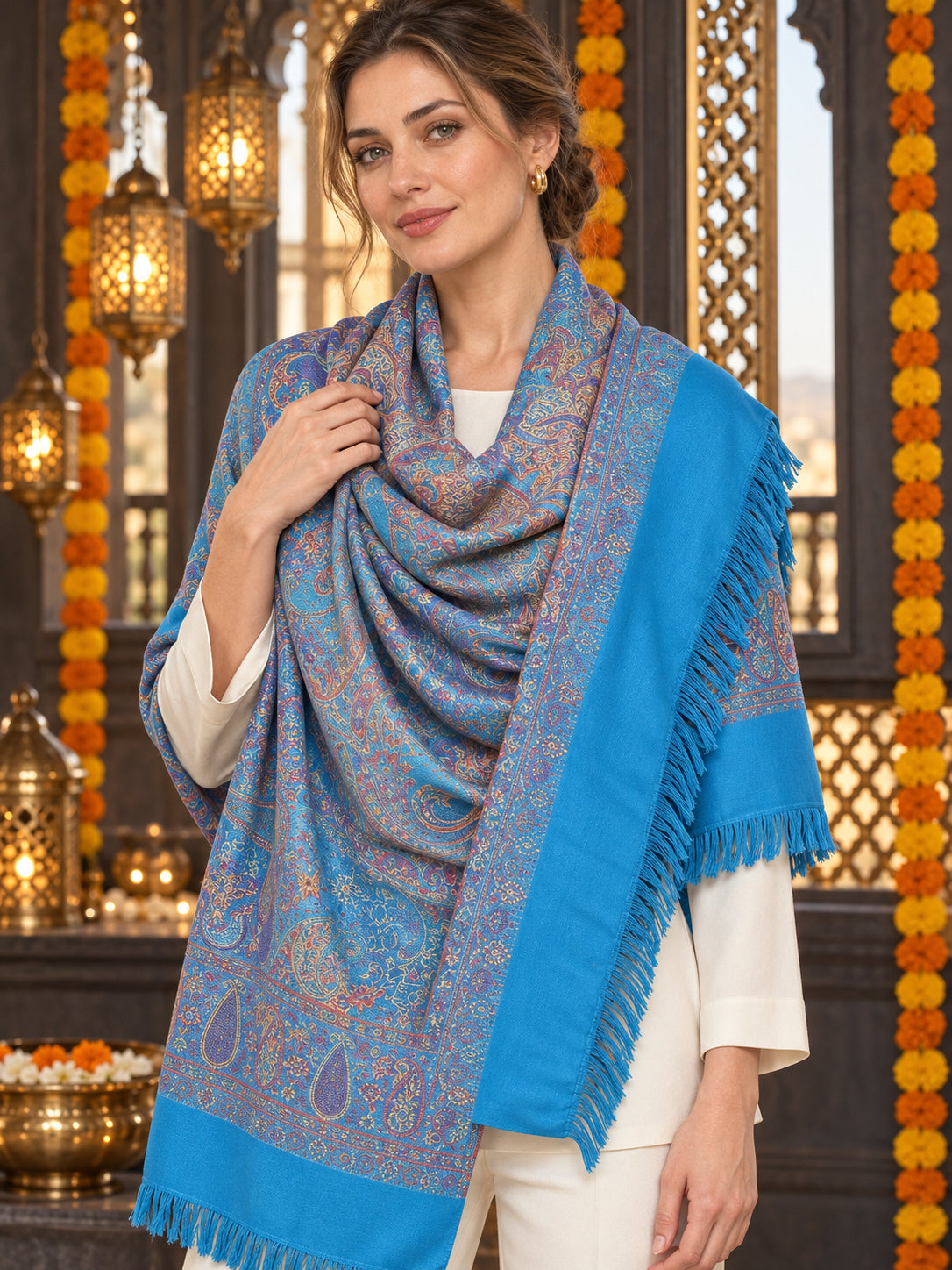Sky Blue paisley woven shawl styled on a model in a luxurious festive palace setting — detailed shoulder wrap