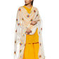 A woman wearing a yellow suit with a dupatta featuring colorful floral hand embroidery over her shoulders.