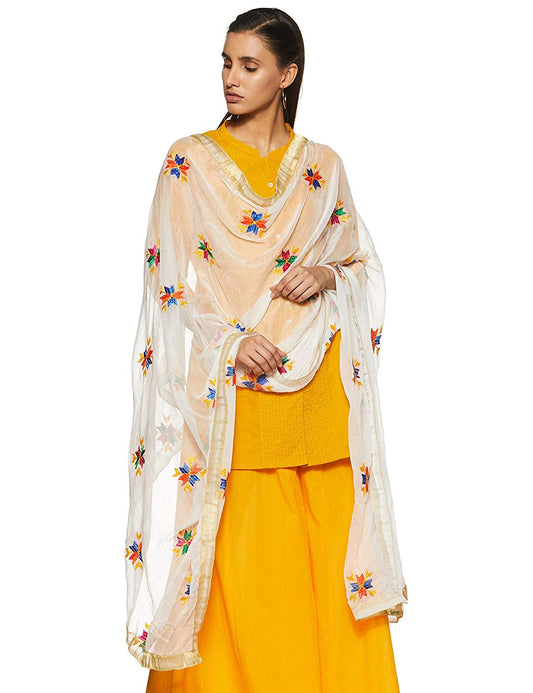 A woman wearing a yellow suit with a dupatta featuring colorful floral hand embroidery over her shoulders.